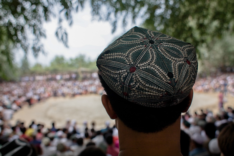 A man sporting a dopa (traditional hat) at a local wrestling match, Khotan, 2008 