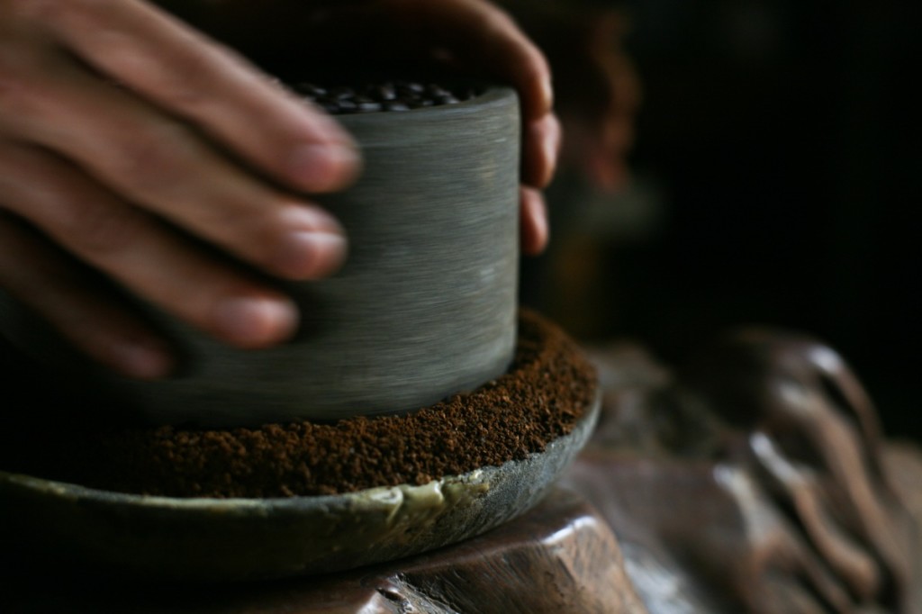 An old traditional coffee grinder being used in Hainan, China