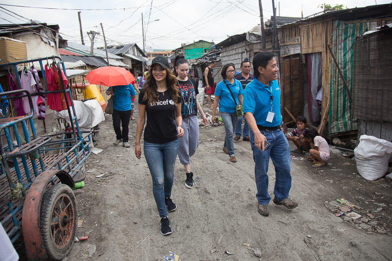 Nicole and UNICEF staff walking through Baseco Compound